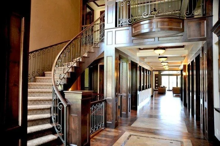 Grand entry with custom stairway, hand railings, and paneling by TG Woodworking