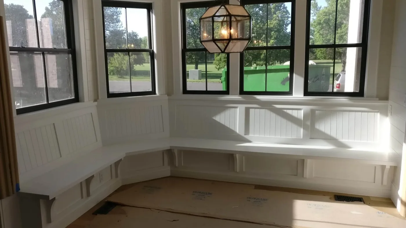 Window bench with wainscoting and paneling by TG Woodworking