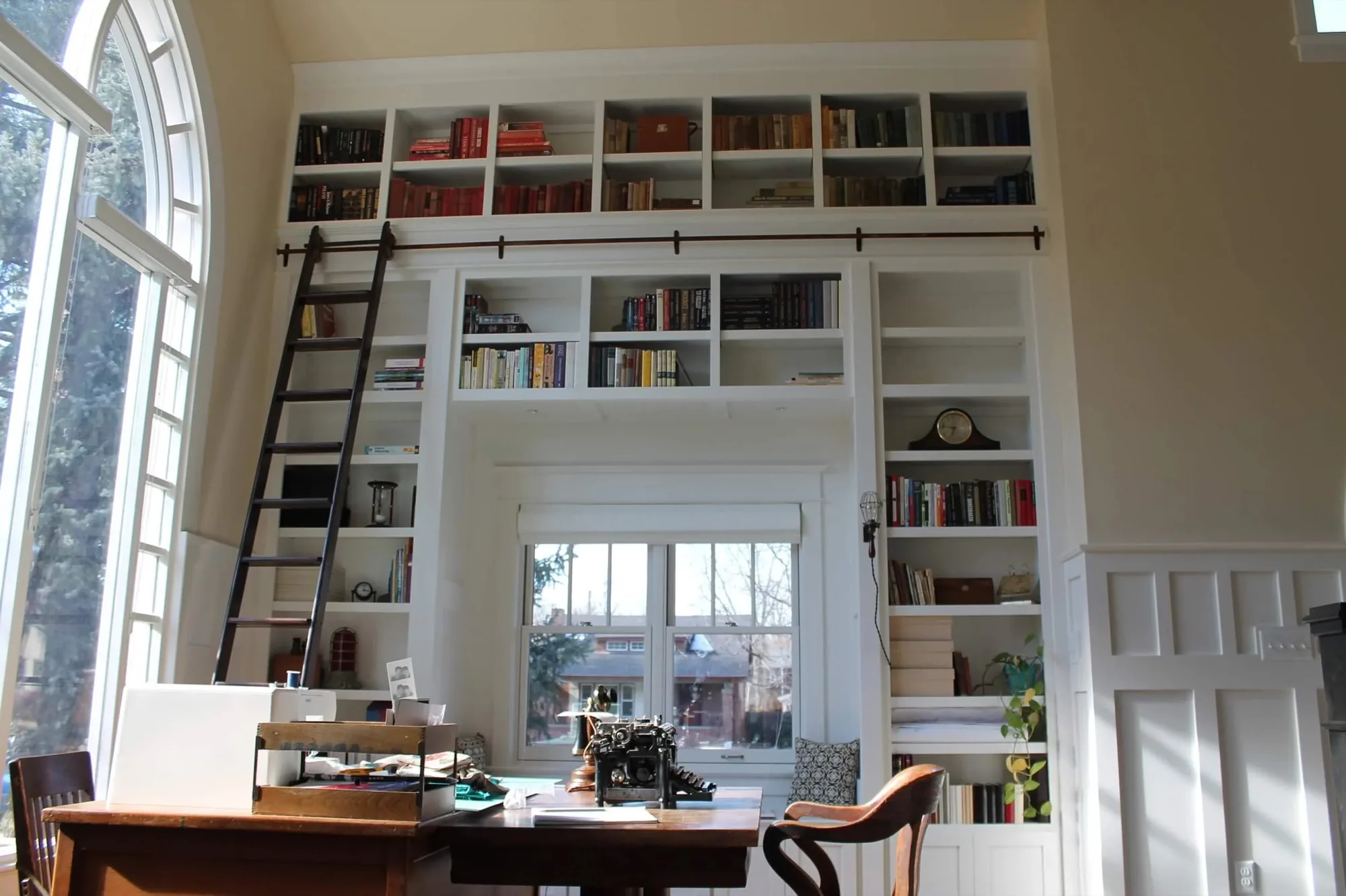 Floor to ceiling built-in library with rolling ladder by TG Woodworking