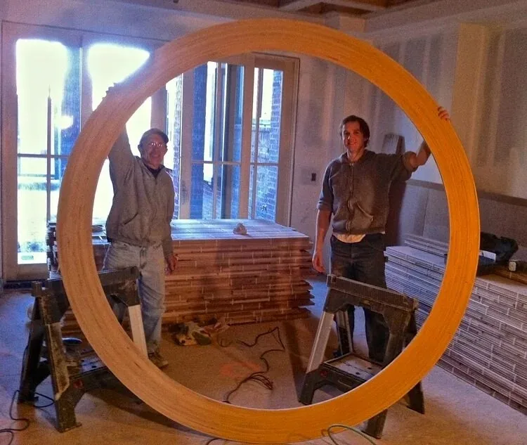 Tyler Gady and his father Rich Gady working together on circular ceiling beams
