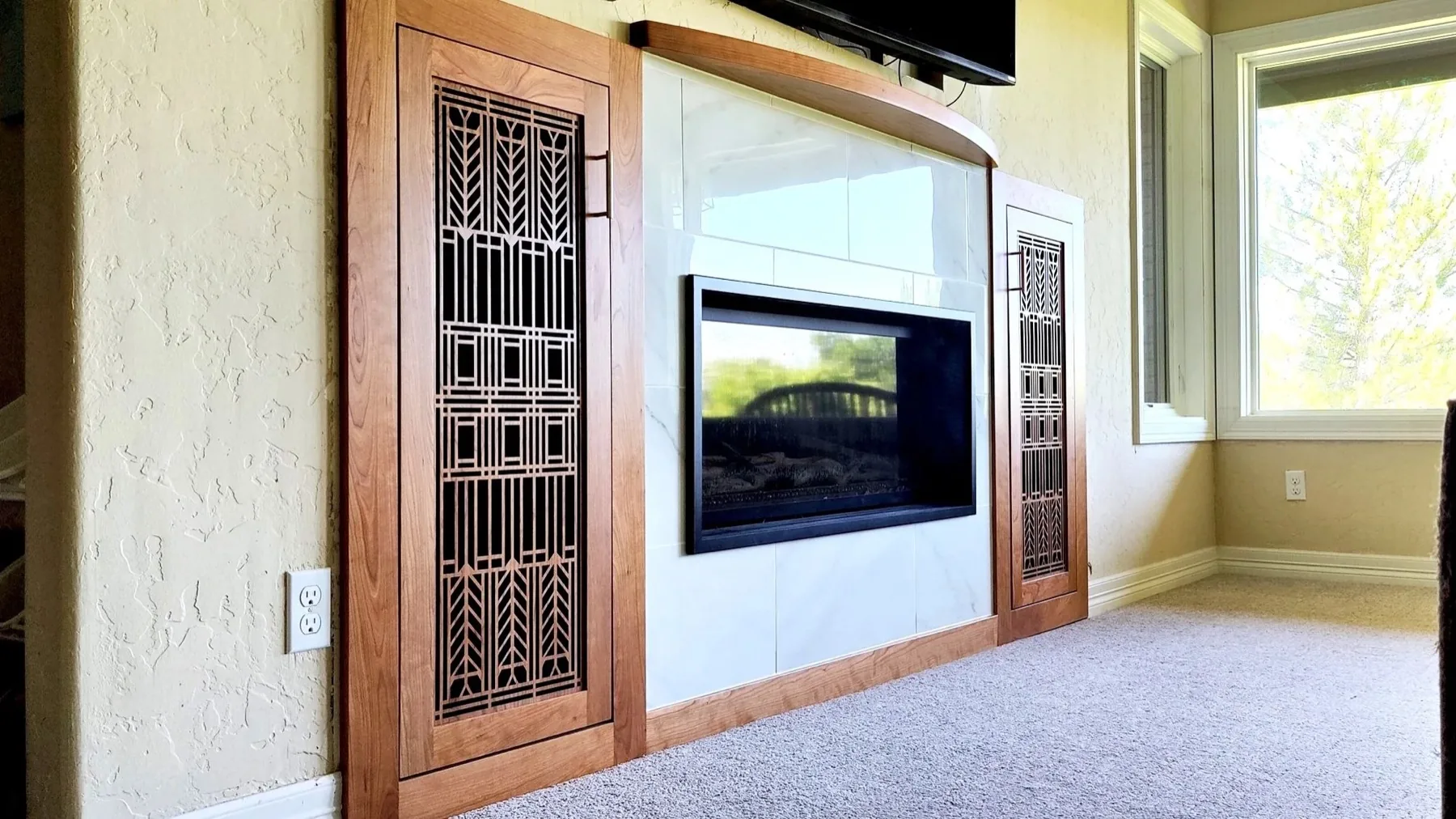 Custom cherry built-in cabinetry with decorative fretwork doors by TG Woodworking