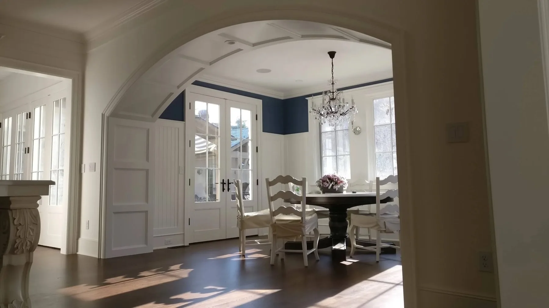 Residential remodel with arched paneling and coffered ceiling by TG Woodworking